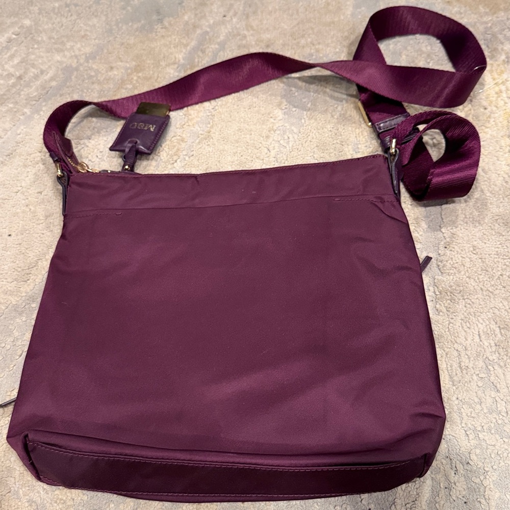TUMI
Voyageur Capri Crossbody plum purple color in GUC - Picture 6 of 12